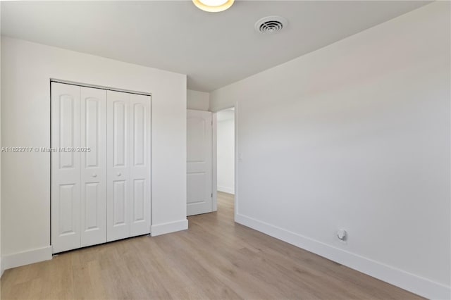 5401 Fillmore St, Hollywood, FL 33021 - unfurnished bedroom with light wood finished floors and a closet