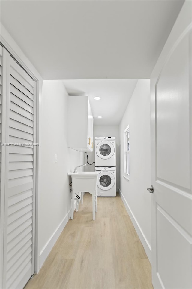 5401 Fillmore St, Hollywood, FL 33021 - laundry area featuring stacked washer and clothes dryer, light wood-type flooring, and recessed lighting