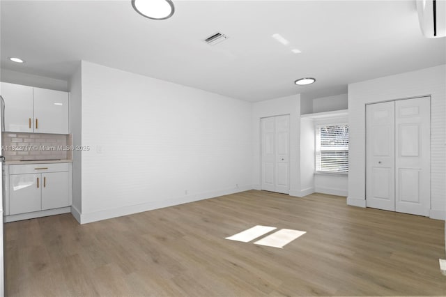 5401 Fillmore St, Hollywood, FL 33021 - unfurnished bedroom featuring multiple closets, light wood-type flooring, and recessed lighting