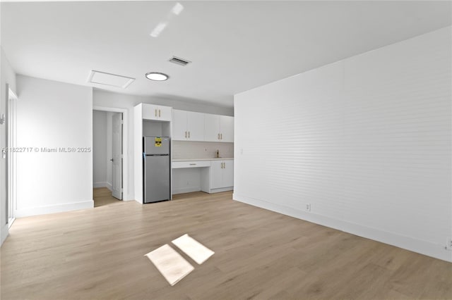 5401 Fillmore St, Hollywood, FL 33021 - unfurnished living room featuring attic access and light wood-style flooring