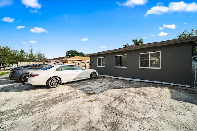 1250 NE 110th St, Miami, FL 33161 - view of front of house featuring stucco siding and uncovered parking