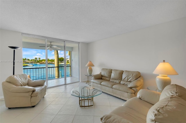 777 S Federal Hwy Unit 201G, Pompano Beach, FL 33062 - living area featuring floor to ceiling windows, a textured ceiling, a water view, and light tile patterned floors