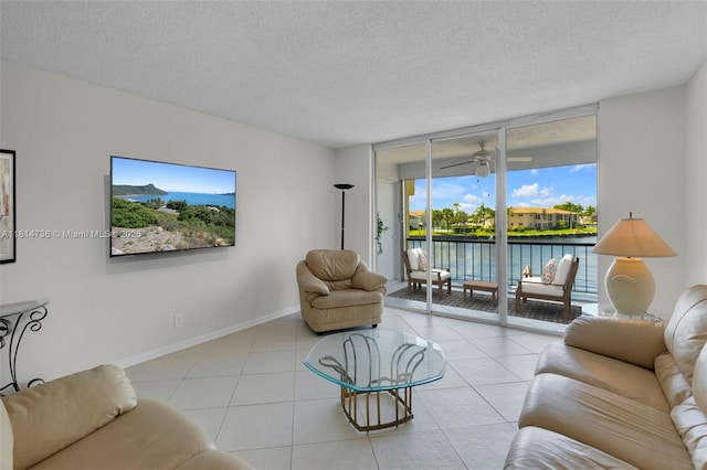 777 S Federal Hwy Unit 201G, Pompano Beach, FL 33062 - tiled living area featuring a textured ceiling and a ceiling fan
