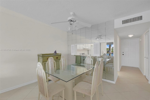 777 S Federal Hwy Unit 201G, Pompano Beach, FL 33062 - dining space with light tile patterned floors, ceiling fan, and a textured ceiling