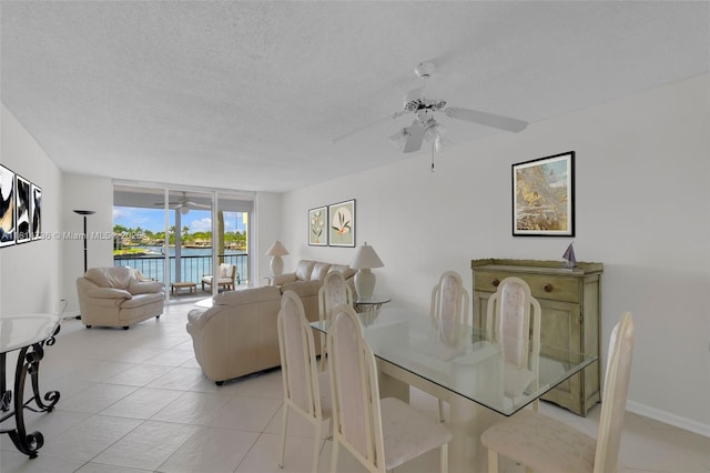 777 S Federal Hwy Unit 201G, Pompano Beach, FL 33062 - dining area with ceiling fan, light tile patterned floors, expansive windows, a water view, and a textured ceiling