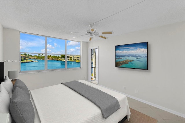 777 S Federal Hwy Unit 201G, Pompano Beach, FL 33062 - bedroom with ceiling fan, tile patterned floors, and a textured ceiling
