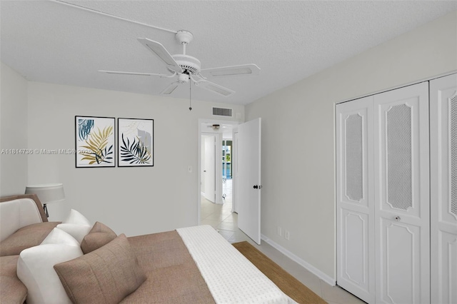 777 S Federal Hwy Unit 201G, Pompano Beach, FL 33062 - bedroom with a closet, ceiling fan, a textured ceiling, and light tile patterned flooring