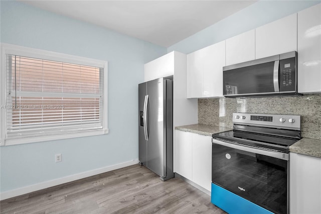 15452 SW 138th Ter, Miami, FL 33196 - kitchen featuring appliances with stainless steel finishes, decorative backsplash, light wood finished floors, and white cabinetry