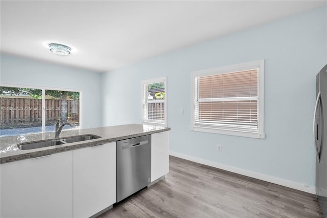 15452 SW 138th Ter, Miami, FL 33196 - kitchen with stainless steel appliances, white cabinets, plenty of natural light, and light wood-type flooring
