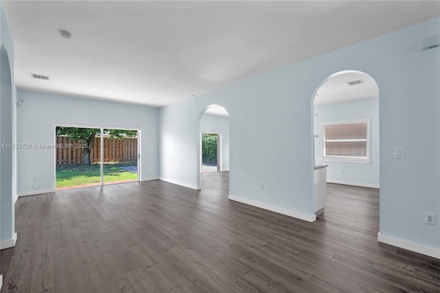 15452 SW 138th Ter, Miami, FL 33196 - spare room featuring arched walkways, a smoke detector, and dark wood-type flooring