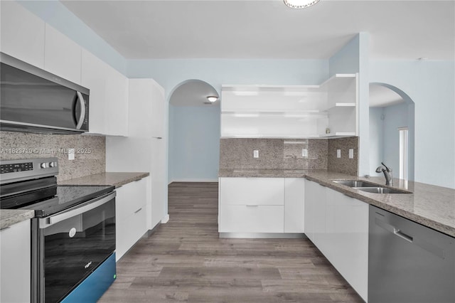 15452 SW 138th Ter, Miami, FL 33196 - kitchen with stainless steel appliances, arched walkways, modern cabinets, and white cabinetry