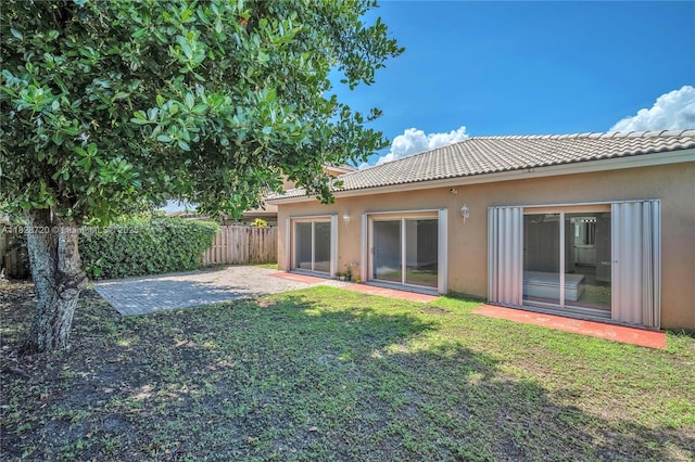15452 SW 138th Ter, Miami, FL 33196 - rear view of house with a tiled roof, stucco siding, and a patio
