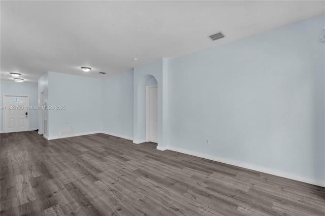 15452 SW 138th Ter, Miami, FL 33196 - spare room featuring arched walkways and wood finished floors