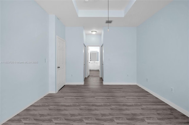 15452 SW 138th Ter, Miami, FL 33196 - spare room featuring a tray ceiling and wood finished floors