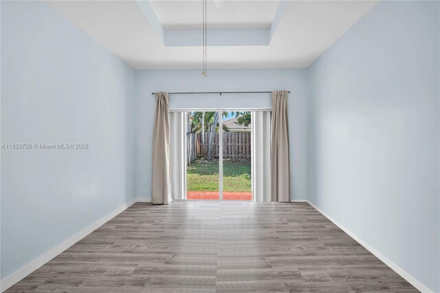 15452 SW 138th Ter, Miami, FL 33196 - unfurnished room with a tray ceiling and wood finished floors