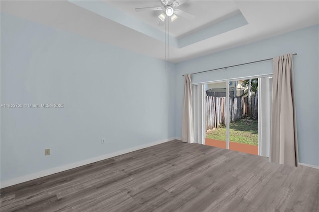 15452 SW 138th Ter, Miami, FL 33196 - empty room with wood finished floors, a ceiling fan, and a raised ceiling