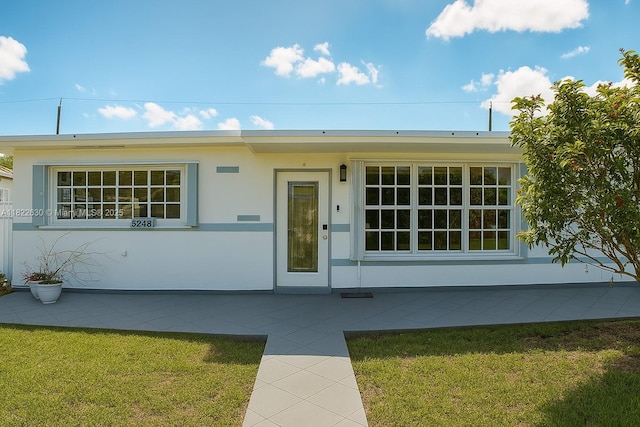 5348 W 14th Ave, Hialeah, FL 33012 - view of front of house with a front lawn and stucco siding