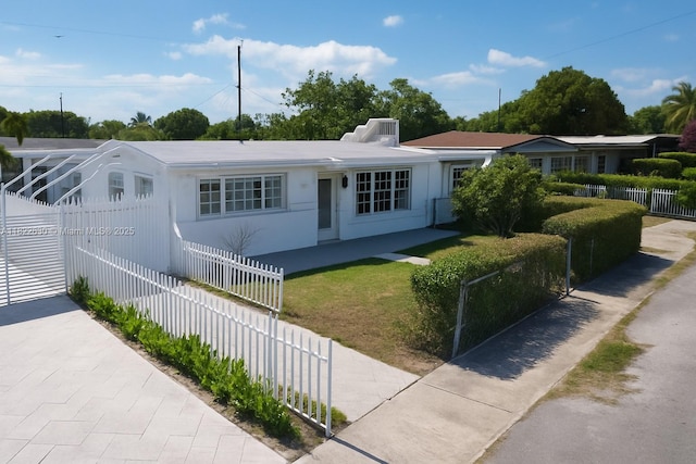 5348 W 14th Ave, Hialeah, FL 33012 - ranch-style home featuring a fenced front yard and stucco siding