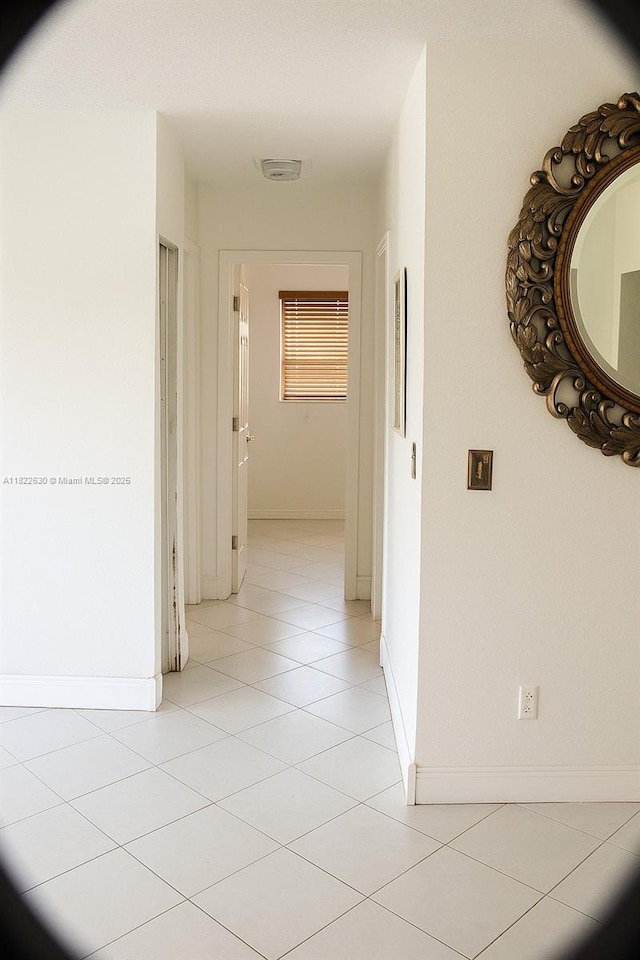 5348 W 14th Ave, Hialeah, FL 33012 - hall featuring light tile patterned floors and baseboards