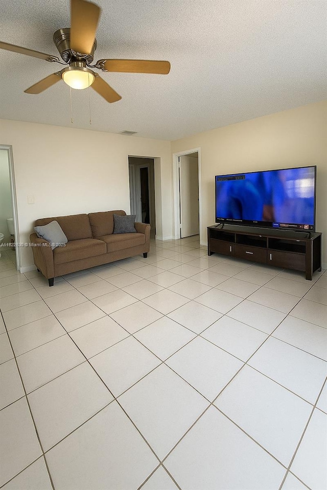 5348 W 14th Ave, Hialeah, FL 33012 - living area with a ceiling fan, a textured ceiling, and light tile patterned floors
