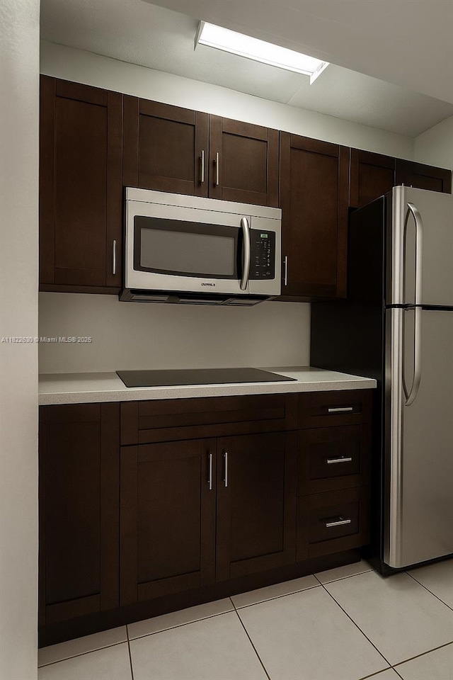 5348 W 14th Ave, Hialeah, FL 33012 - kitchen with appliances with stainless steel finishes, dark brown cabinets, light tile patterned floors, and light countertops