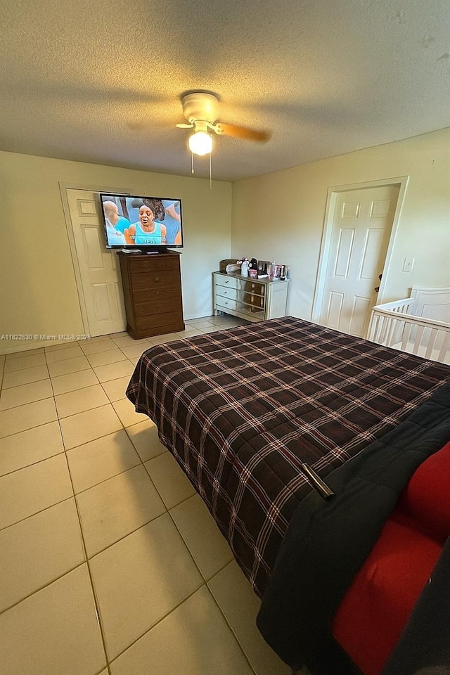 5348 W 14th Ave, Hialeah, FL 33012 - bedroom with tile patterned flooring, a ceiling fan, and a textured ceiling
