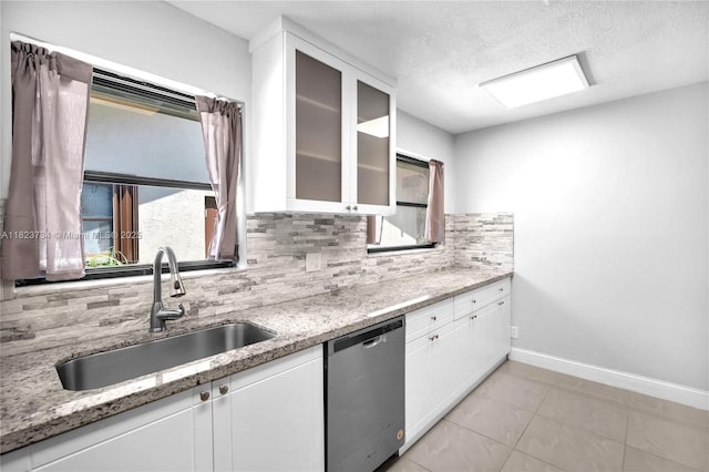 2035 SW 15th Ct, Deerfield Beach, FL 33442 - kitchen with stainless steel dishwasher, backsplash, white cabinets, light stone countertops, and glass insert cabinets