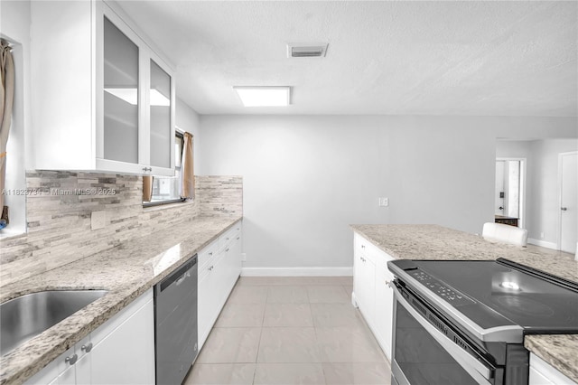 2035 SW 15th Ct, Deerfield Beach, FL 33442 - kitchen with stainless steel appliances, backsplash, white cabinetry, a textured ceiling, and glass insert cabinets