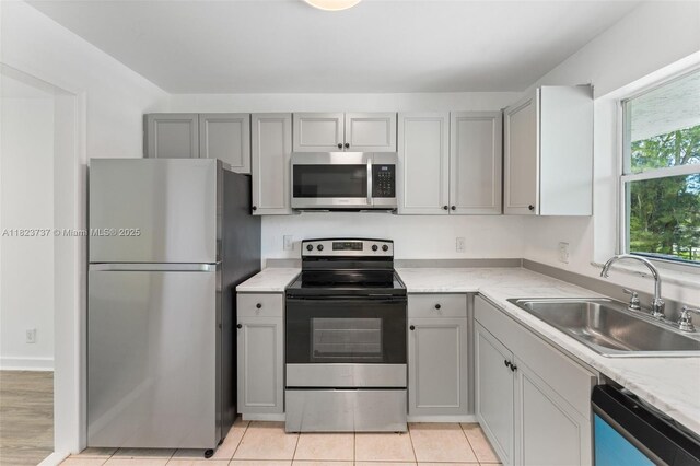 5100 SW 64th Ave Unit 204A, Davie, FL 33314 - kitchen with stainless steel appliances, gray cabinets, and light tile patterned floors