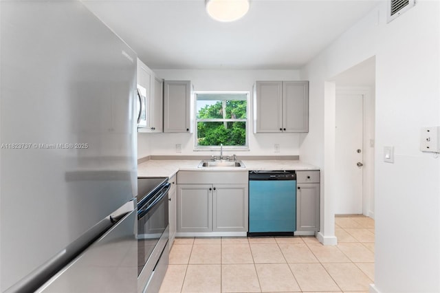 5100 SW 64th Ave Unit 204A, Davie, FL 33314 - kitchen featuring appliances with stainless steel finishes, gray cabinetry, light tile patterned floors, and light countertops