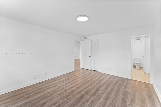 5100 SW 64th Ave Unit 204A, Davie, FL 33314 - unfurnished bedroom with wood finished floors, ensuite bath, and a closet