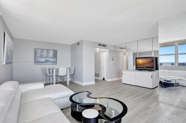 2639 N Riverside Dr Unit 1203, Pompano Beach, FL 33062 - living area with light wood-style floors and baseboards