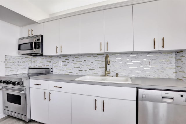 2639 N Riverside Dr Unit 1203, Pompano Beach, FL 33062 - kitchen with appliances with stainless steel finishes, decorative backsplash, white cabinetry, and light wood-style flooring
