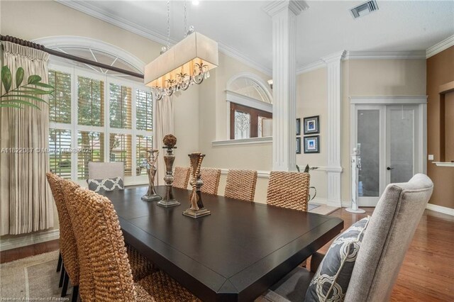3859 Enchanted Oaks Ln, Sebring, FL 33875 - dining area with ornate columns, wood finished floors, and ornamental molding
