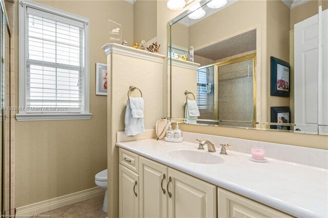 3859 Enchanted Oaks Ln, Sebring, FL 33875 - bathroom featuring plenty of natural light, vanity, tile patterned floors, a tile shower, and ornamental molding