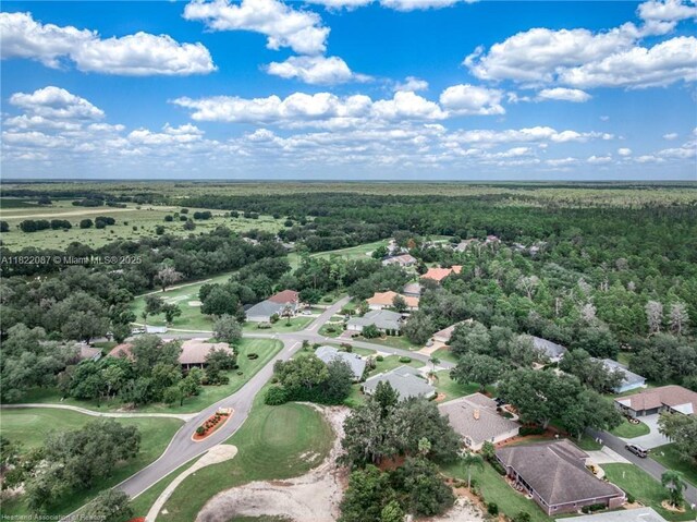 3859 Enchanted Oaks Ln, Sebring, FL 33875 - aerial overview of property's location with nearby suburban area and a forest