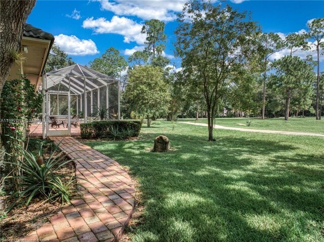 3859 Enchanted Oaks Ln, Sebring, FL 33875 - view of green lawn with a lanai and a patio