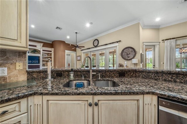 3859 Enchanted Oaks Ln, Sebring, FL 33875 - kitchen featuring ceiling fan, light brown cabinetry, crown molding, stainless steel dishwasher, and dark stone countertops