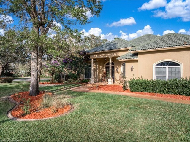 3859 Enchanted Oaks Ln, Sebring, FL 33875 - view of side of property featuring a tile roof, stucco siding, and a yard