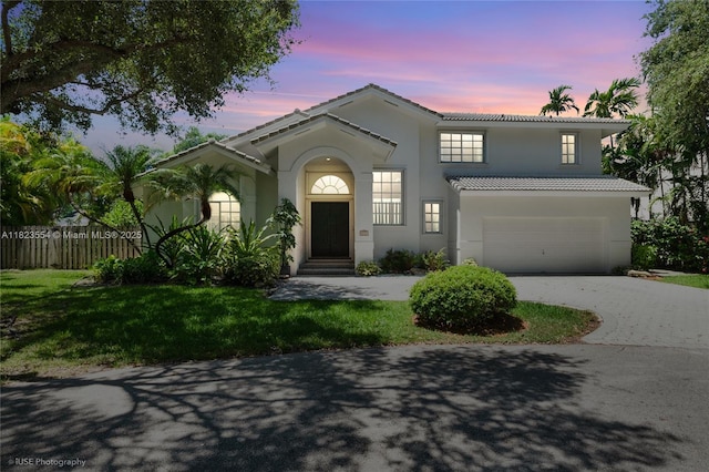 6670 SW 69th Ln, South Miami, FL 33143 - mediterranean / spanish house featuring an attached garage, a tile roof, concrete driveway, and stucco siding