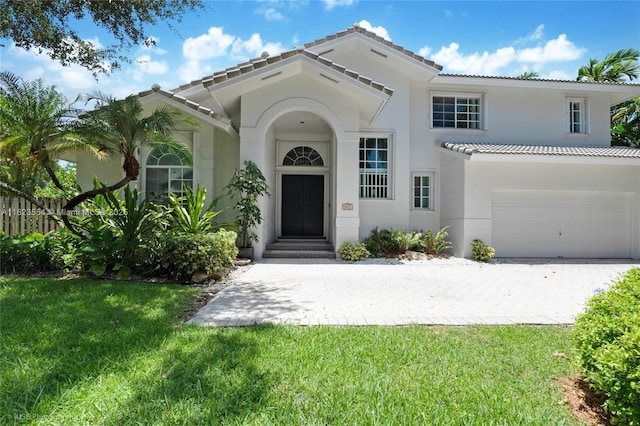 6670 SW 69th Ln, South Miami, FL 33143 - mediterranean / spanish-style house with a tiled roof, stucco siding, an attached garage, and driveway