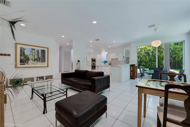 6670 SW 69th Ln, South Miami, FL 33143 - living room with light tile patterned flooring and recessed lighting