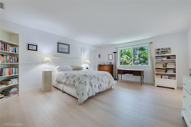 6670 SW 69th Ln, South Miami, FL 33143 - bedroom featuring light wood-type flooring and baseboards