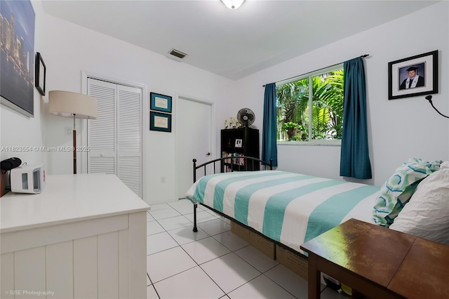 6670 SW 69th Ln, South Miami, FL 33143 - bedroom featuring light tile patterned floors and a closet
