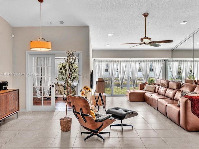 3920 NW 20th St, Coconut Creek, FL 33066 - living room featuring ceiling fan, light tile patterned floors, recessed lighting, and a textured ceiling