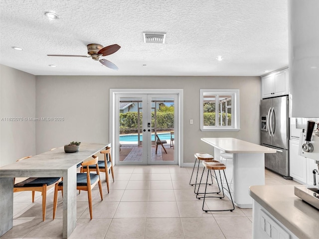 3920 NW 20th St, Coconut Creek, FL 33066 - dining room featuring french doors, a ceiling fan, a textured ceiling, light tile patterned floors, and recessed lighting