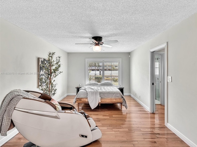 3920 NW 20th St, Coconut Creek, FL 33066 - bedroom featuring light wood-style floors, a textured ceiling, and ceiling fan
