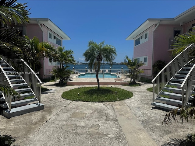 7921 E Dr Unit 8, North Bay Village, FL 33141 - view of swimming pool with stairway and a patio area