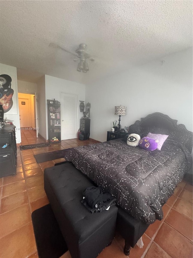 7921 E Dr Unit 8, North Bay Village, FL 33141 - bedroom with tile patterned floors, a textured ceiling, and ceiling fan