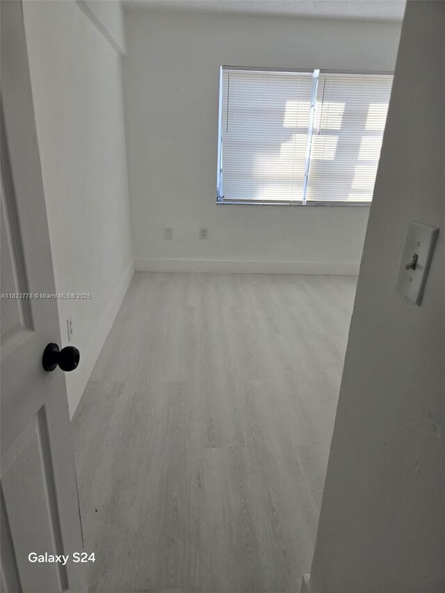 1000 W 28th St Unit 17, Hialeah, FL 33010 - spare room with baseboards and wood finished floors